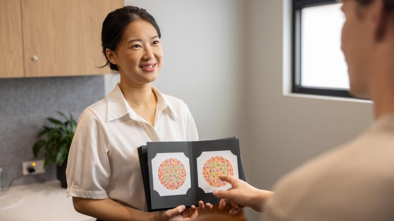 MAX Health practitioner with customer doing vision test