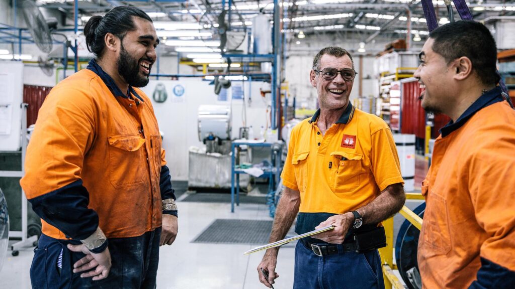 Happy employees in workplace laughing together