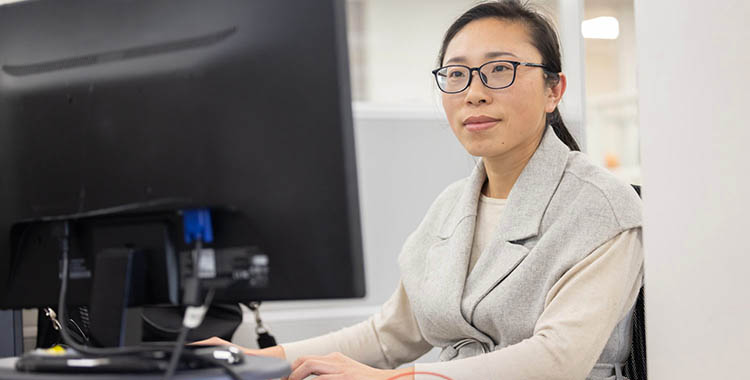 MAX Health staff member looking at computer screen